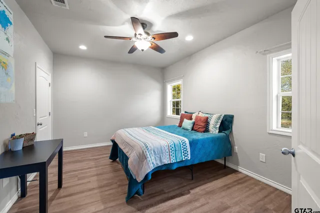a bedroom with a bed and a chandelier