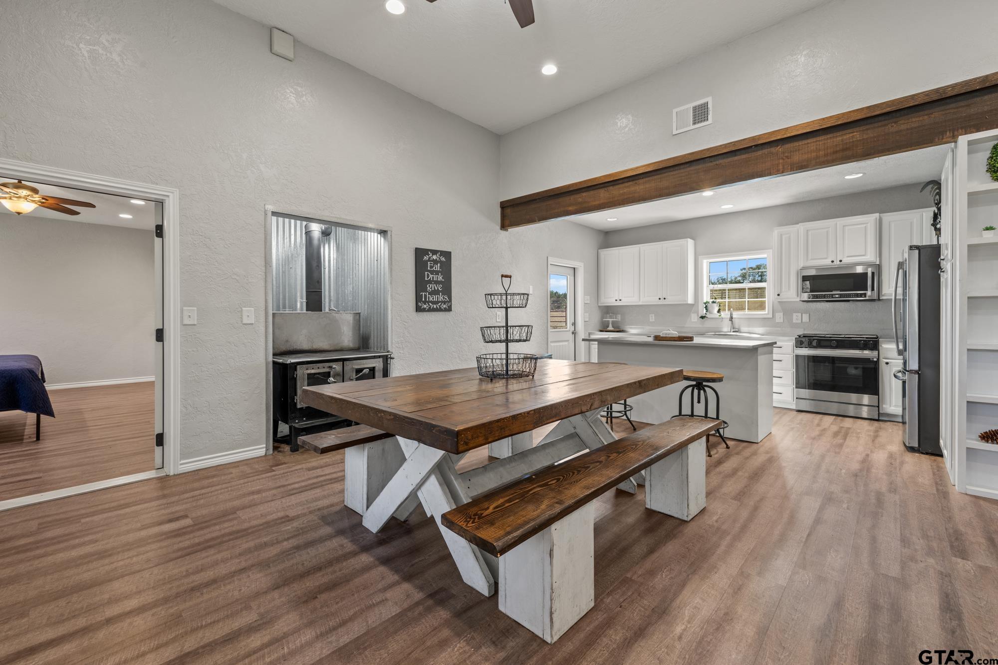 732 Red Maple Road Big Sandy, TX 75755 - Photo 26 of 40 a living room with stainless steel appliances kitchen island granite countertop furniture and a wooden floor