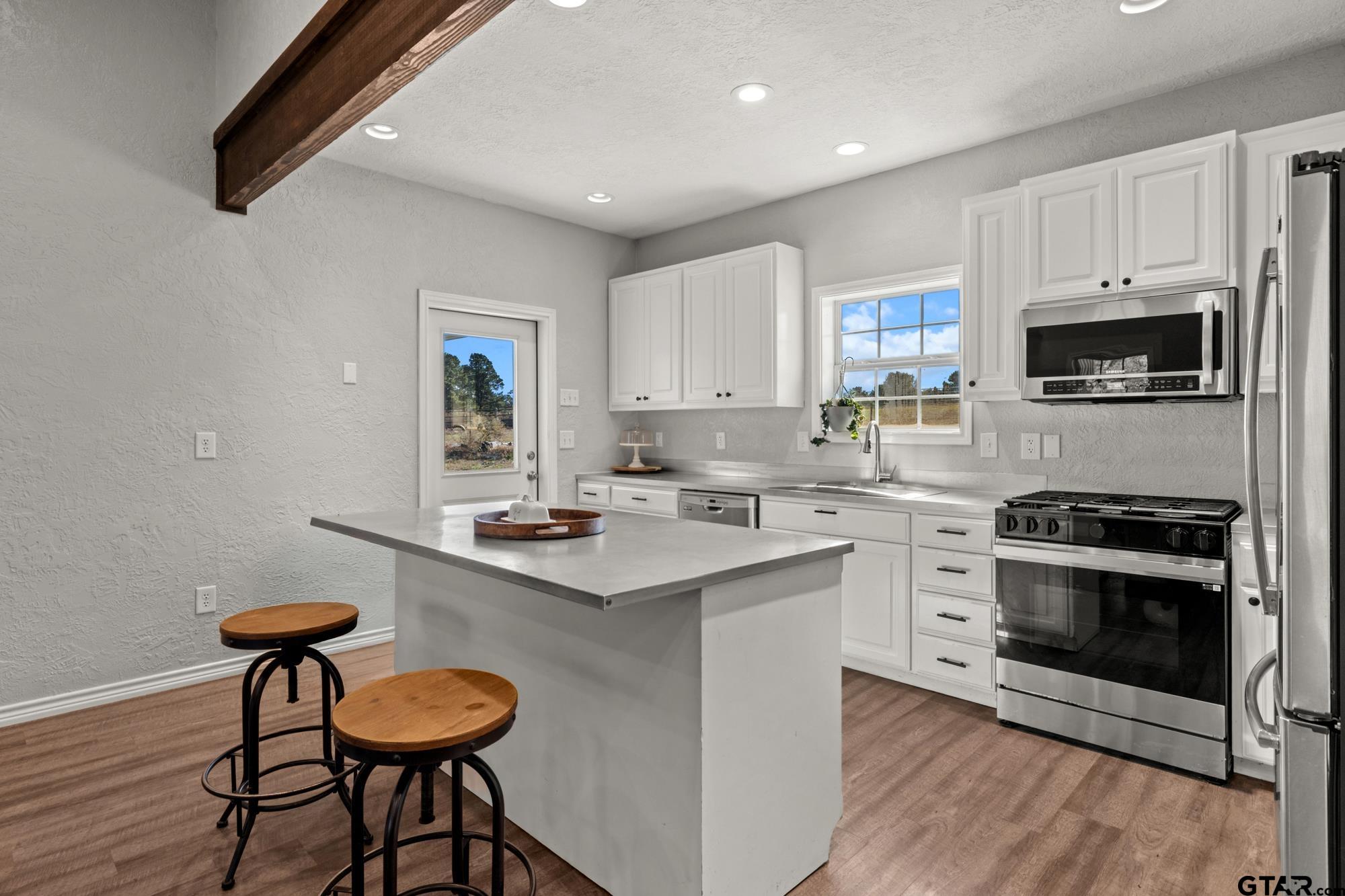 732 Red Maple Road Big Sandy, TX 75755 - Photo 3 of 40 a kitchen with a sink cabinets and window