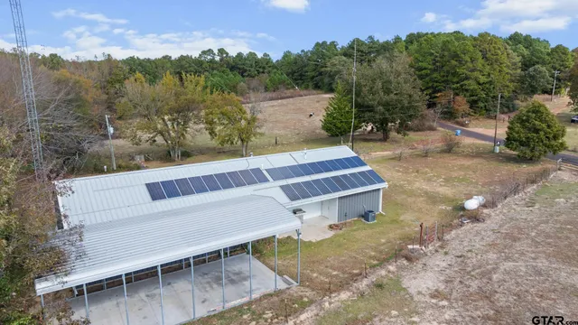 an aerial view of a house with a yard