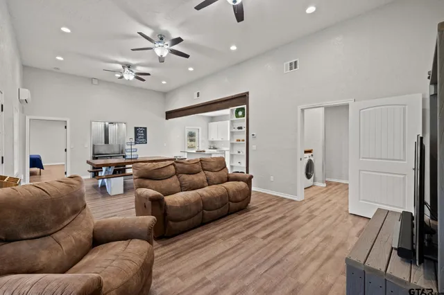 a living room with furniture and a chandelier