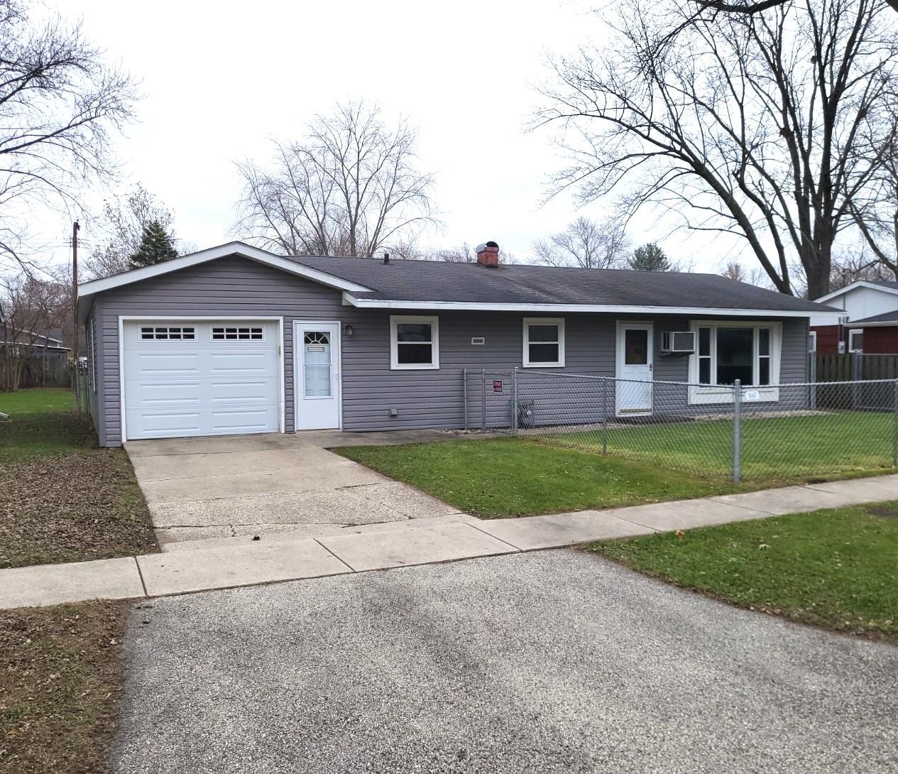 7805 Randy Road Machesney Park, IL 61115 - Photo 1 of 14 a front view of house with yard and green space