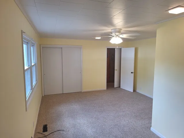 a white toilet sitting next to a shower