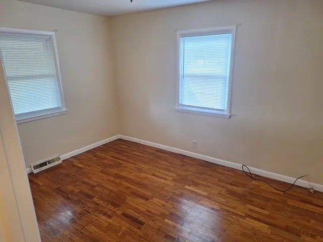 an empty room with wooden floor