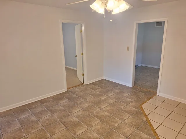 a view of empty room with window and fireplace
