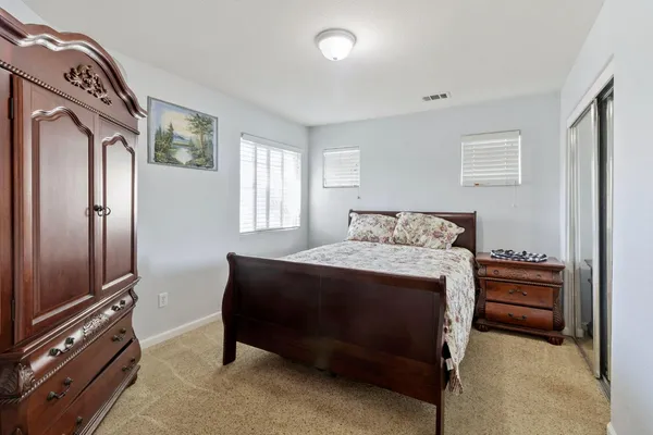 a bedroom with a bed and window