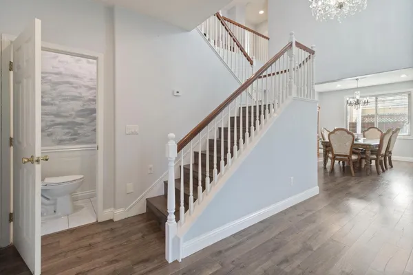a view of a hallway with wooden floor and entryway