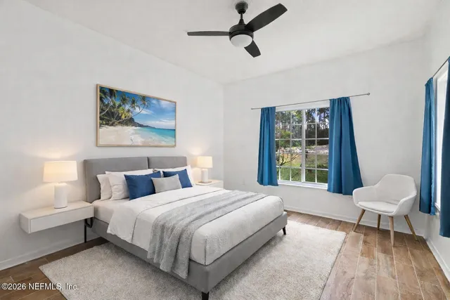 a bedroom with a bed and a window