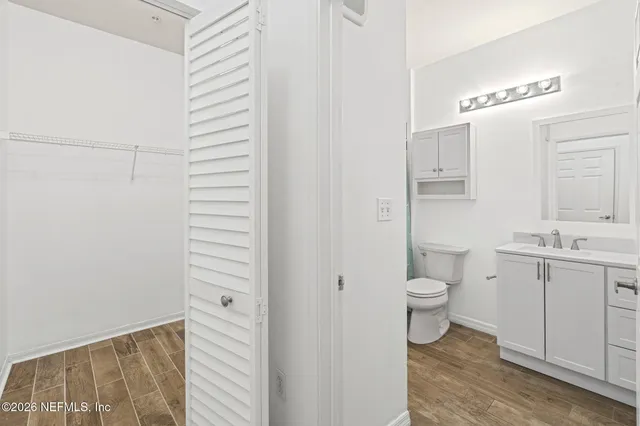 a bathroom with a toilet a sink and a mirror