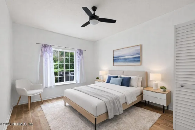 a bedroom with a bed and a window