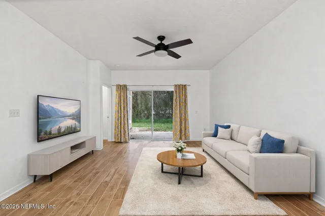 a living room with furniture and a flat screen tv