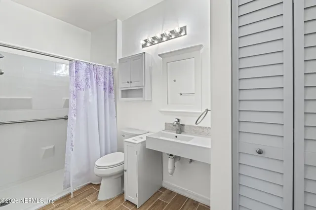 a bathroom with a sink toilet and shower