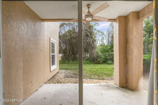 a view of a room with a large window and front door