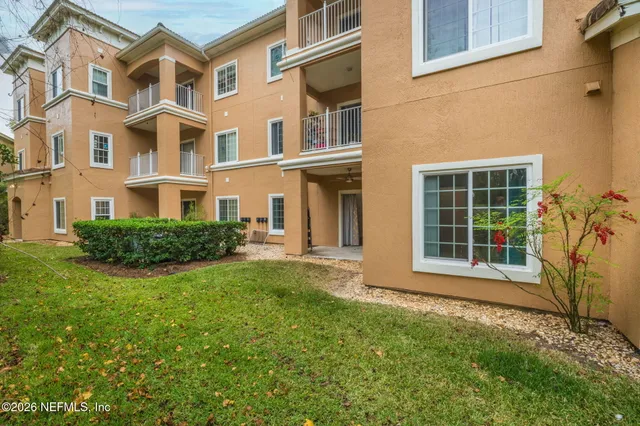a view of a brick building next to a yard