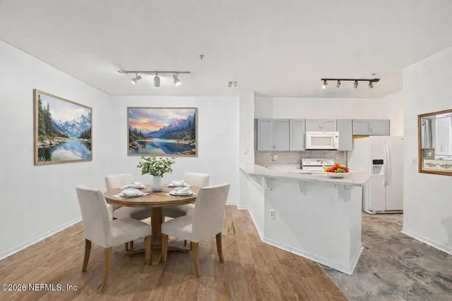 a view of a dining room with furniture and wooden floor