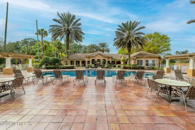 a view of swimming pool with a patio and a yard