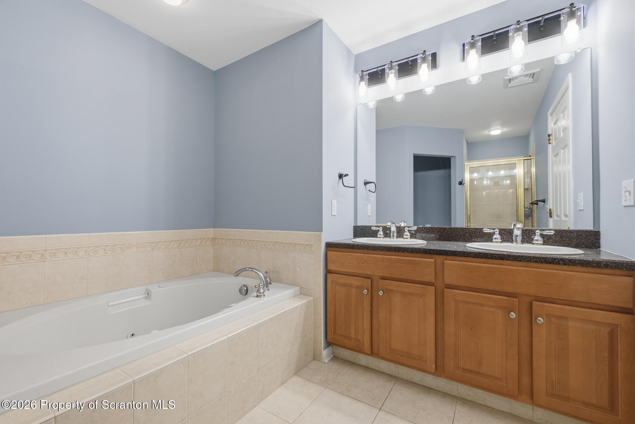 1502 Verne Cl Moosic, PA 18507 - Photo 22 of 46 a spacious bathroom with a bathtub sink and mirror