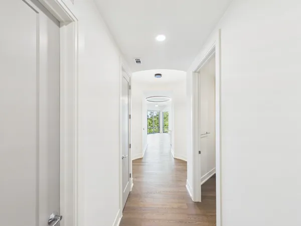 a view of a hallway with wooden floor