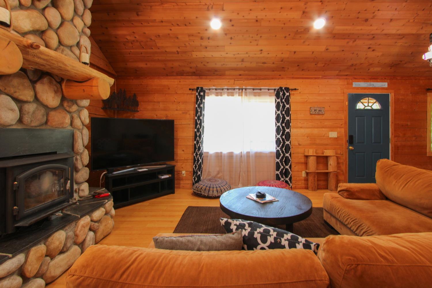 2936 E Highway Murphys, CA 95247 - Photo 21 of 41 a living room with furniture a flat screen tv and a fireplace