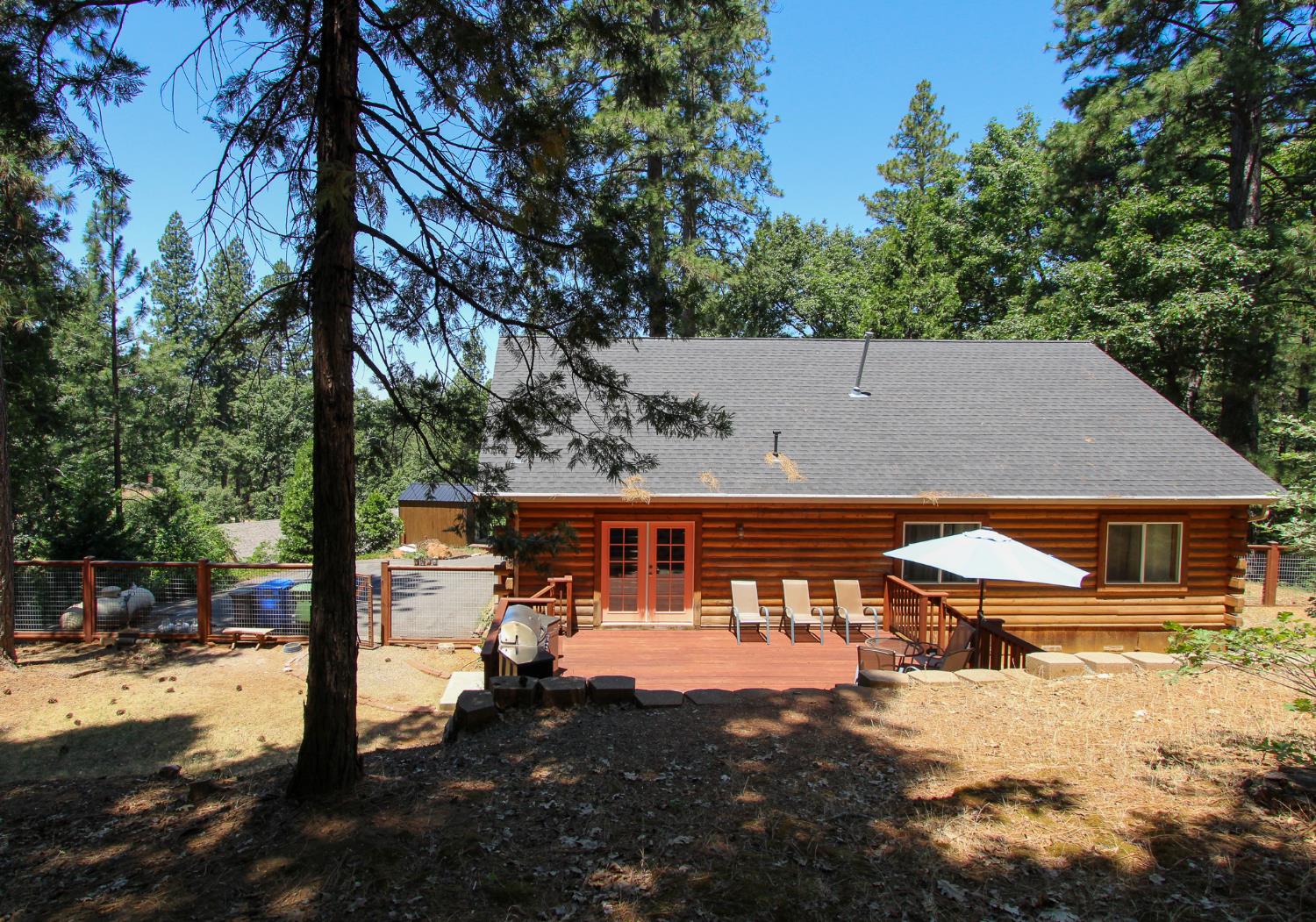 2936 E Highway Murphys, CA 95247 - Photo 10 of 41 a view of a patio with table and chairs under an umbrella
