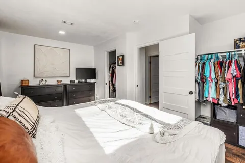 a bed room with a bed and a television