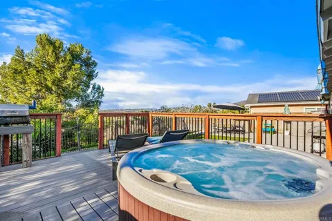 a view of a house with swimming pool and sitting area