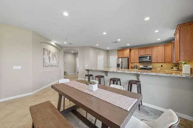 a living room with furniture ceiling fan and a flat screen tv