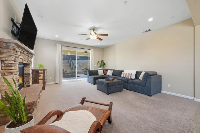 a living room with furniture a flat screen tv and a fireplace