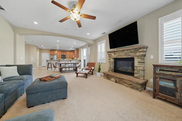 a kitchen with granite countertop a dining table chairs and white cabinets