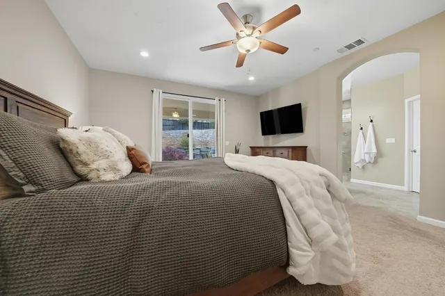 a bed room with a bed a television and a fireplace