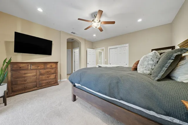 a bathroom with a granite countertop sink a mirror and shower