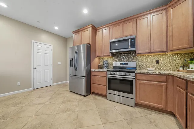a living room with furniture ceiling fan and a flat screen tv
