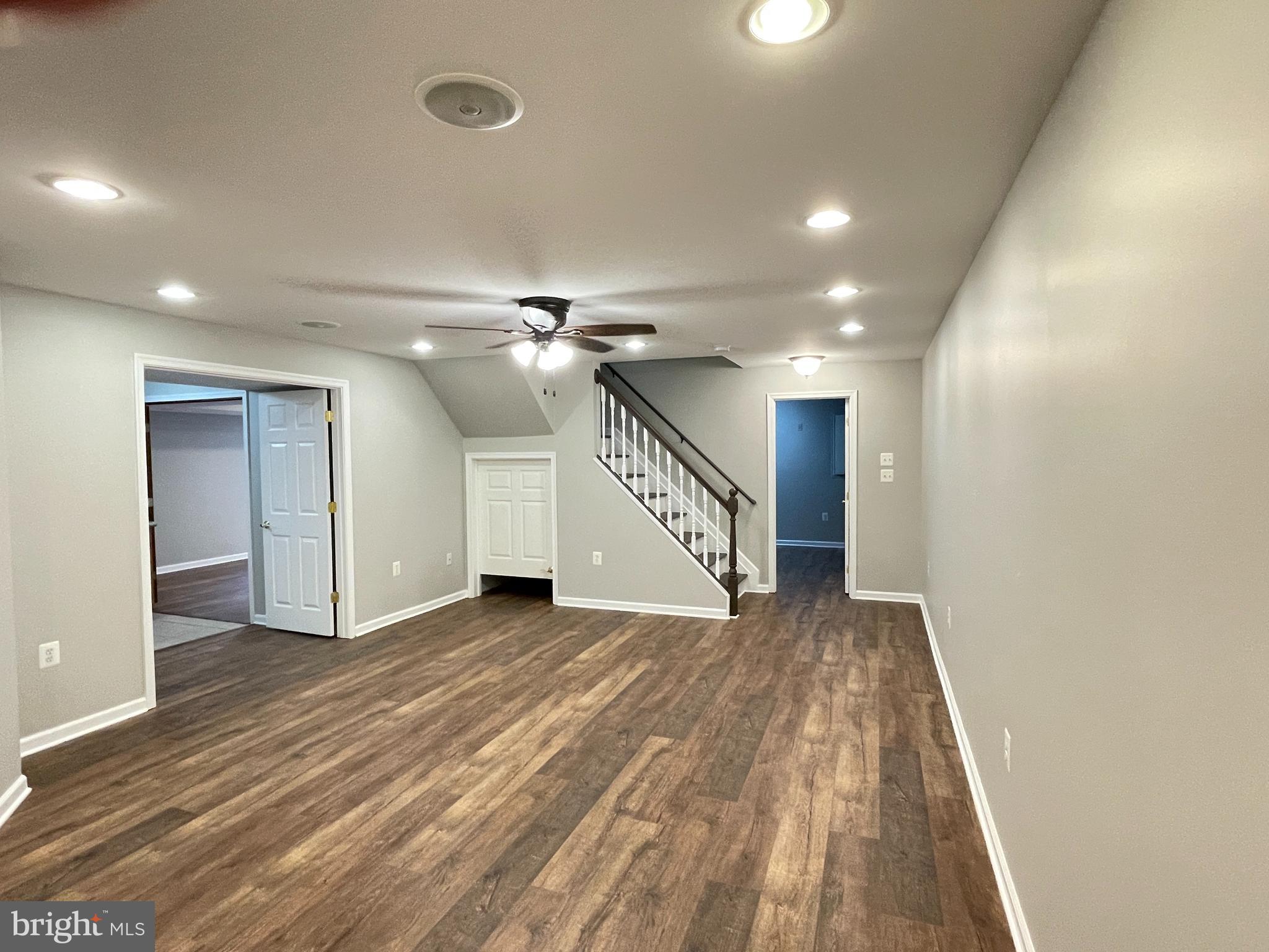 139 Balc Spring Leesburg, VA 20175 - Photo 8 of 18 an empty room with wooden floor fan and windows