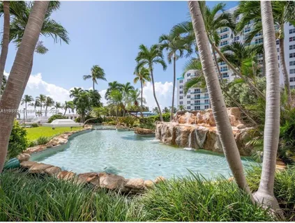 a view of swimming pool with outdoor seating and plants