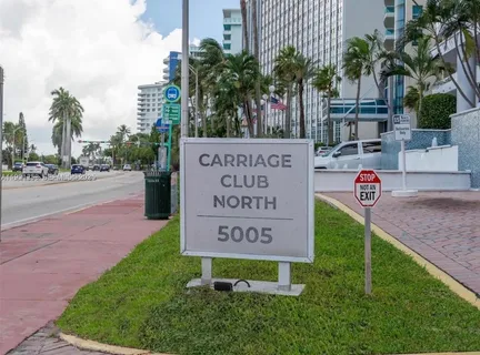 a living room with furniture and large windows