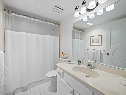 a bathroom with a double vanity sink mirror and toilet