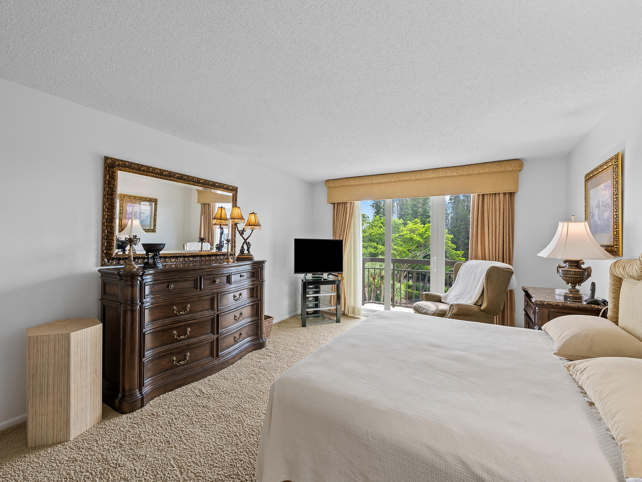 901 East Camino Real, Unit 4D Boca Raton, FL 33432 - Photo 17 of 37 a bedroom with a large bed and a tv