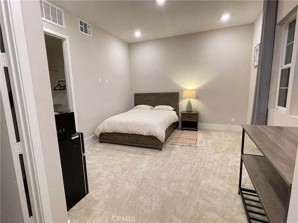 63 Cetus Irvine, CA 92618 - Photo 4 of 9 a bedroom with a bed and a walk in closet