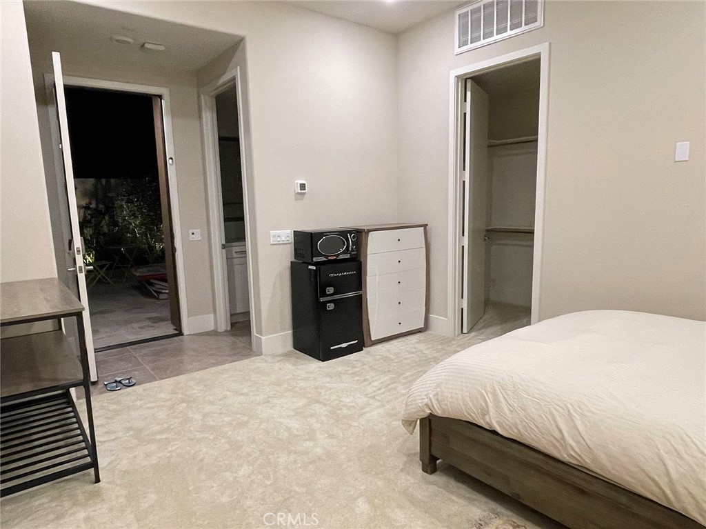 63 Cetus Irvine, CA 92618 - Photo 6 of 9 a spacious bedroom with a bed and a dresser