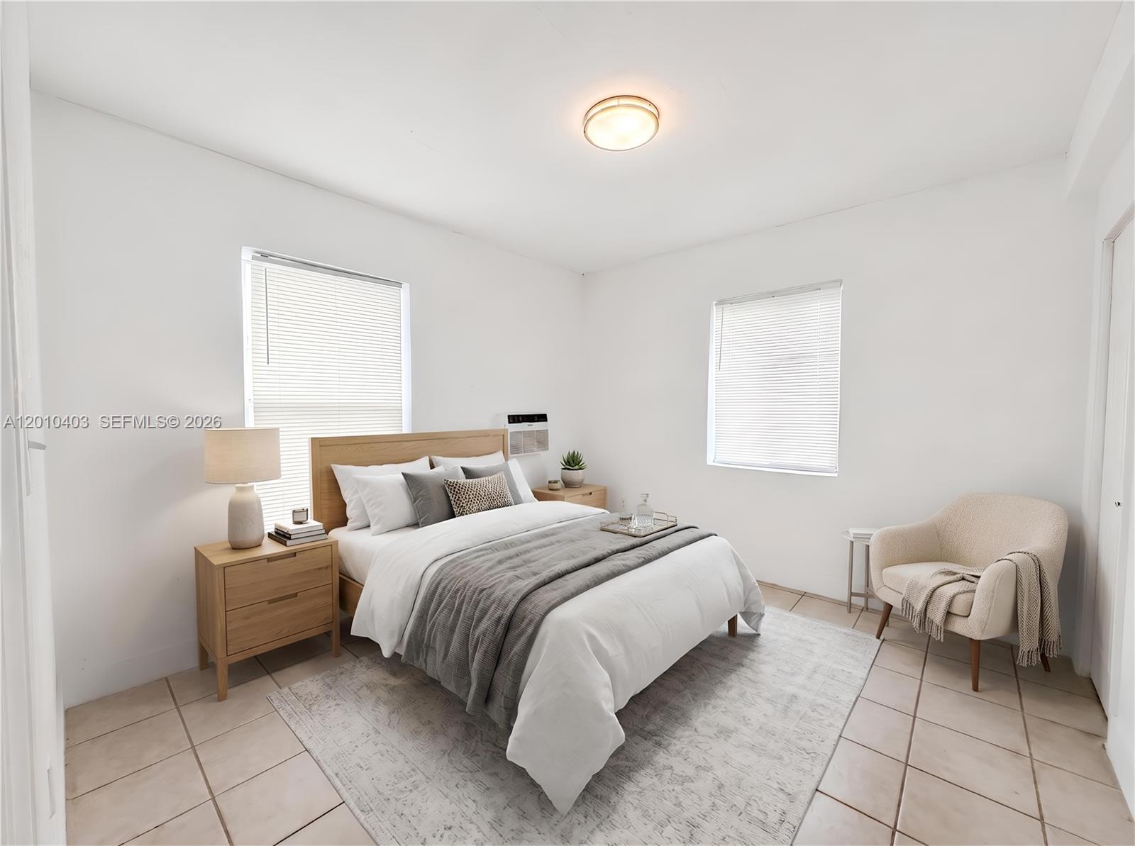 420 Northwest 10th Street, Unit 1 Miami, FL 33136 - Photo 5 of 7 a bedroom with a bed and a window