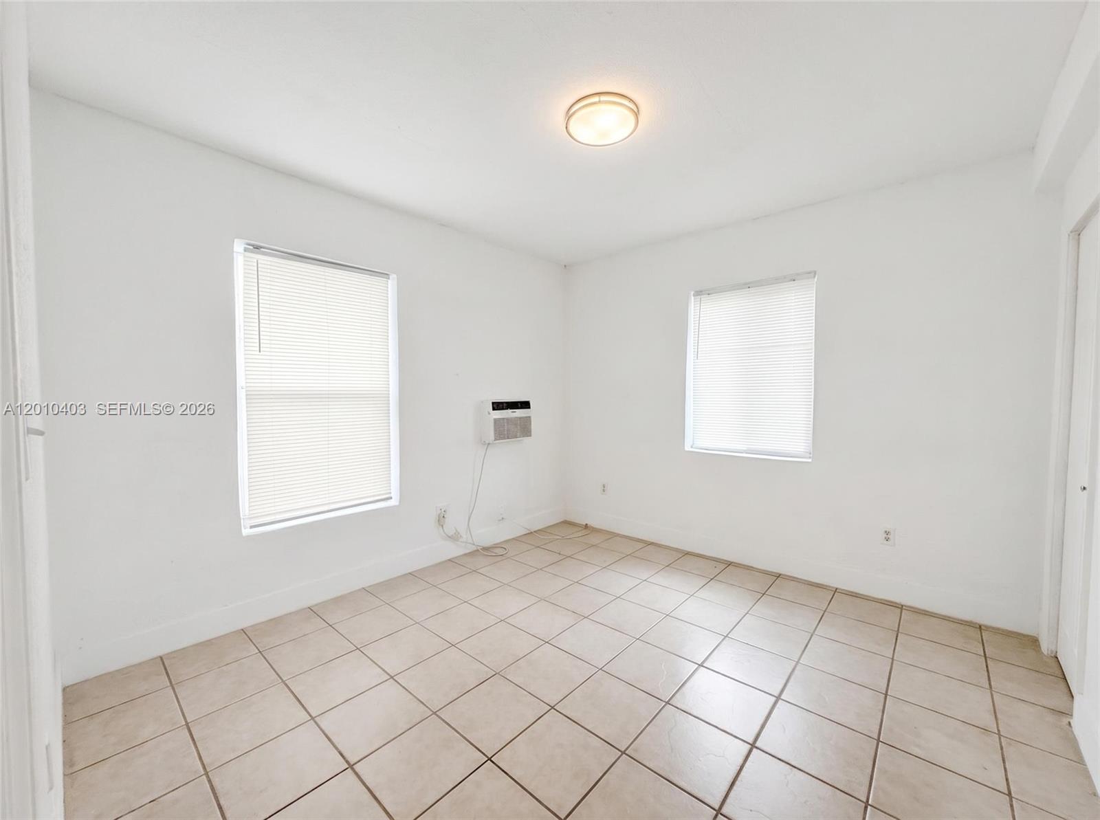 420 Northwest 10th Street, Unit 1 Miami, FL 33136 - Photo 6 of 7 an empty room with windows