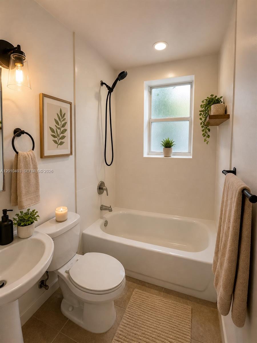 420 Northwest 10th Street, Unit 1 Miami, FL 33136 - Photo 7 of 7 a bathroom with a toilet a sink and bathtub