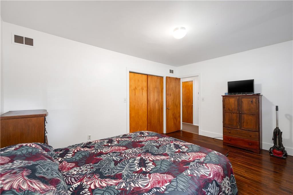411 Harmony Road Baden, PA 15005 - Photo 16 of 25 a bedroom with a bed and a flat screen tv