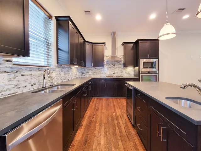 a bathroom with a sink a toilet and a large mirror