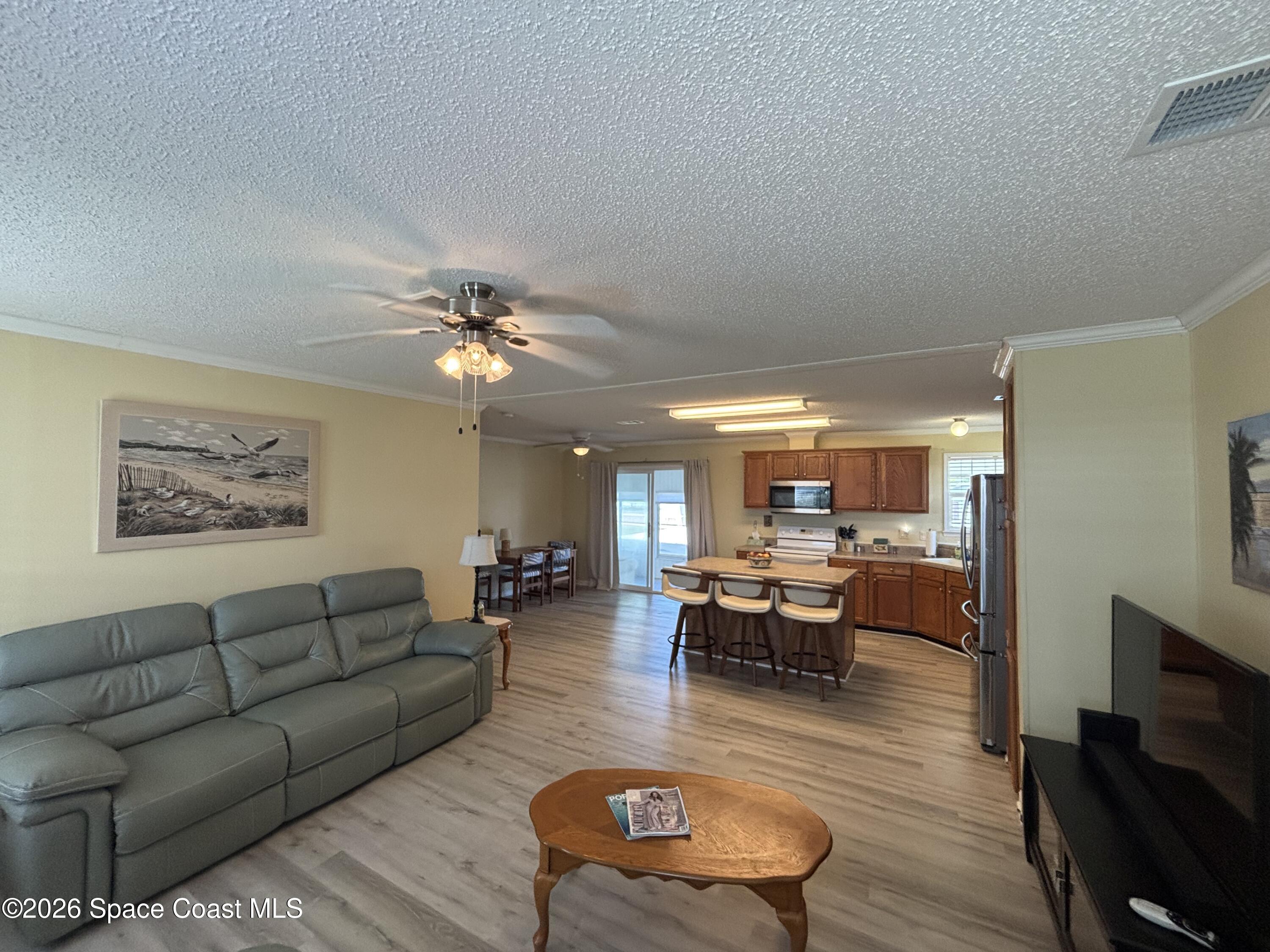 6165 98th Road Sebastian, FL 32958 - Photo 11 of 23 a living room with furniture and a chandelier