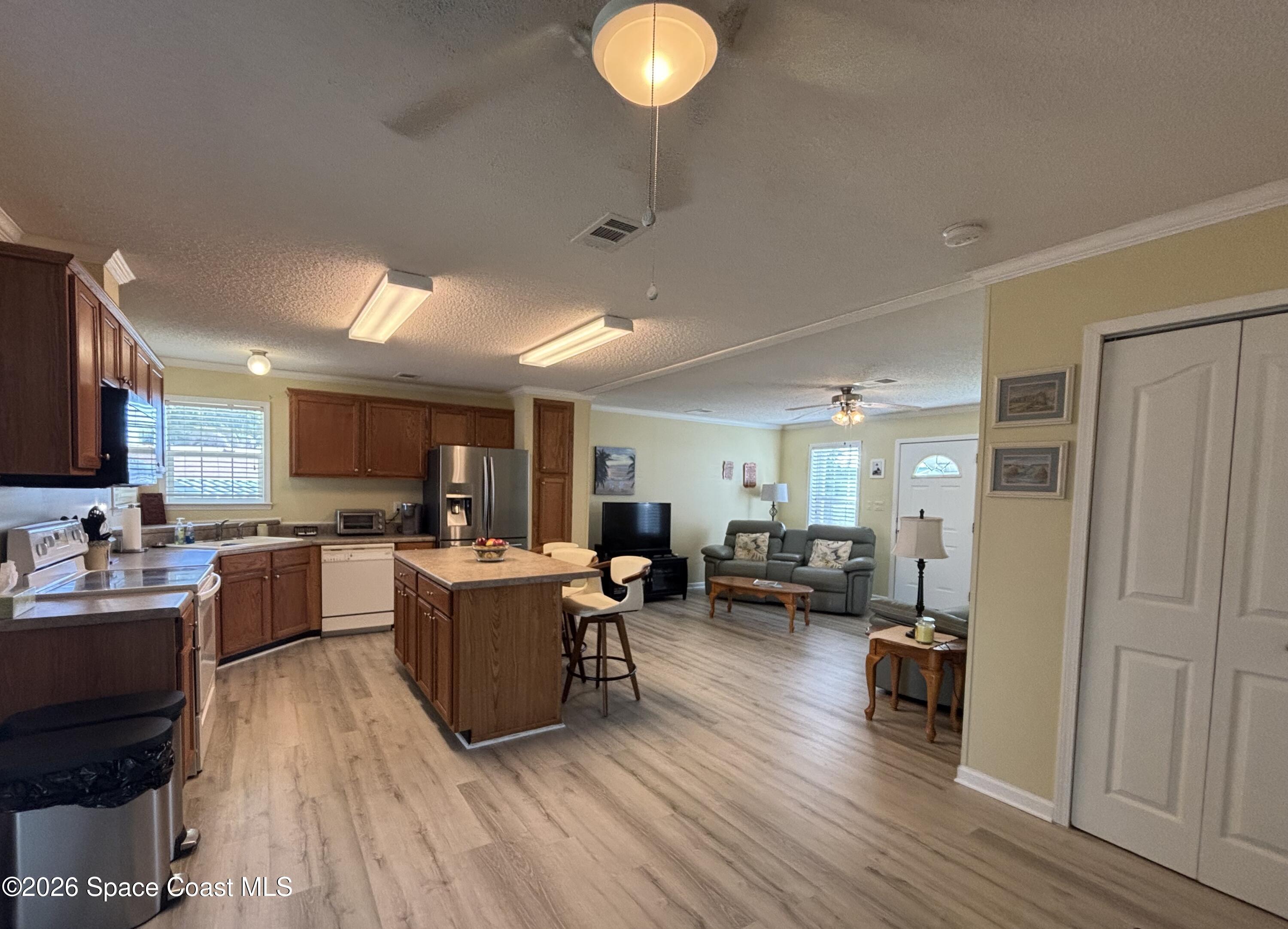 6165 98th Road Sebastian, FL 32958 - Photo 13 of 23 a living room with furniture and a wooden floor