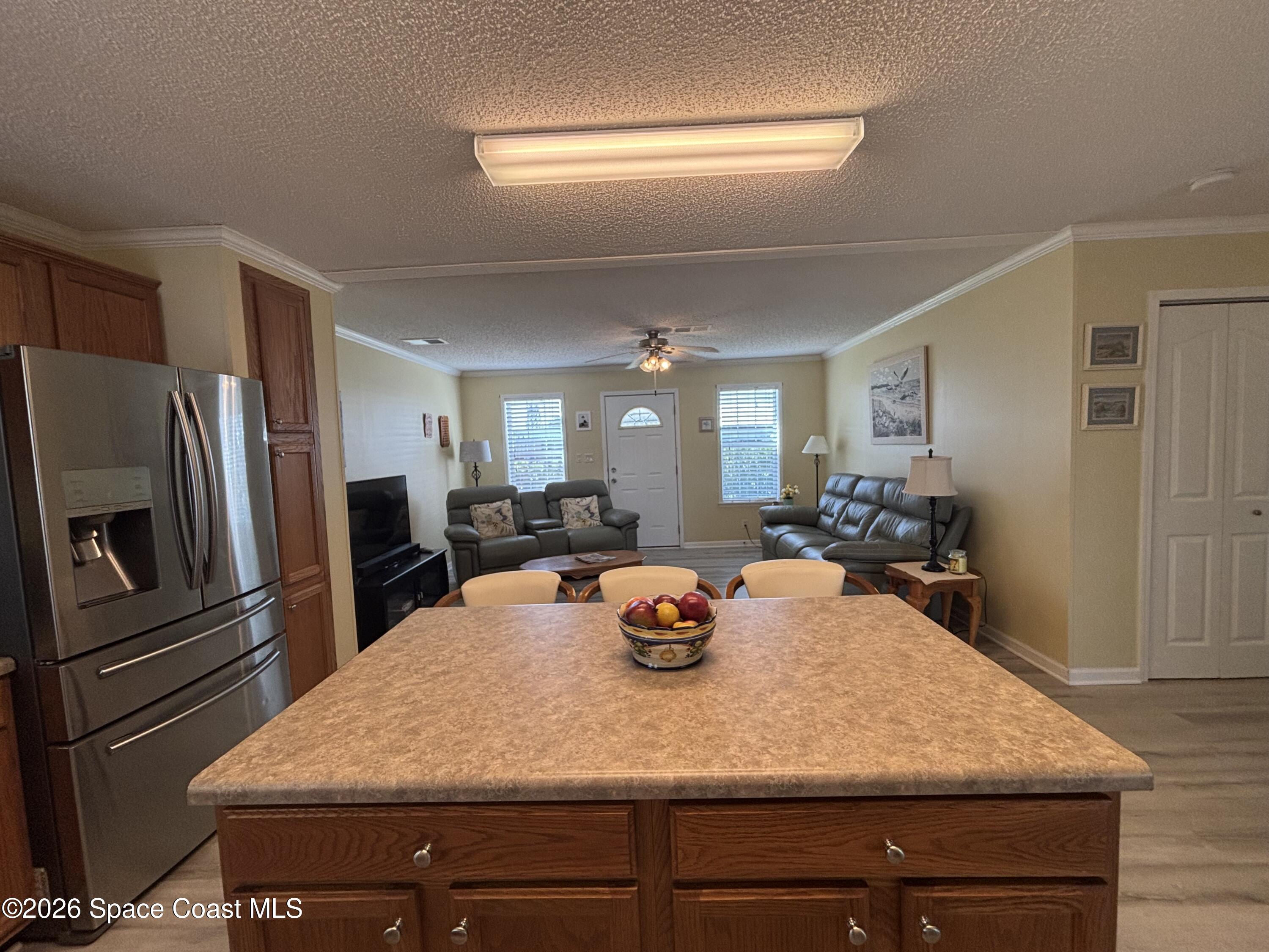 6165 98th Road Sebastian, FL 32958 - Photo 14 of 23 a kitchen with a refrigerator and a sink