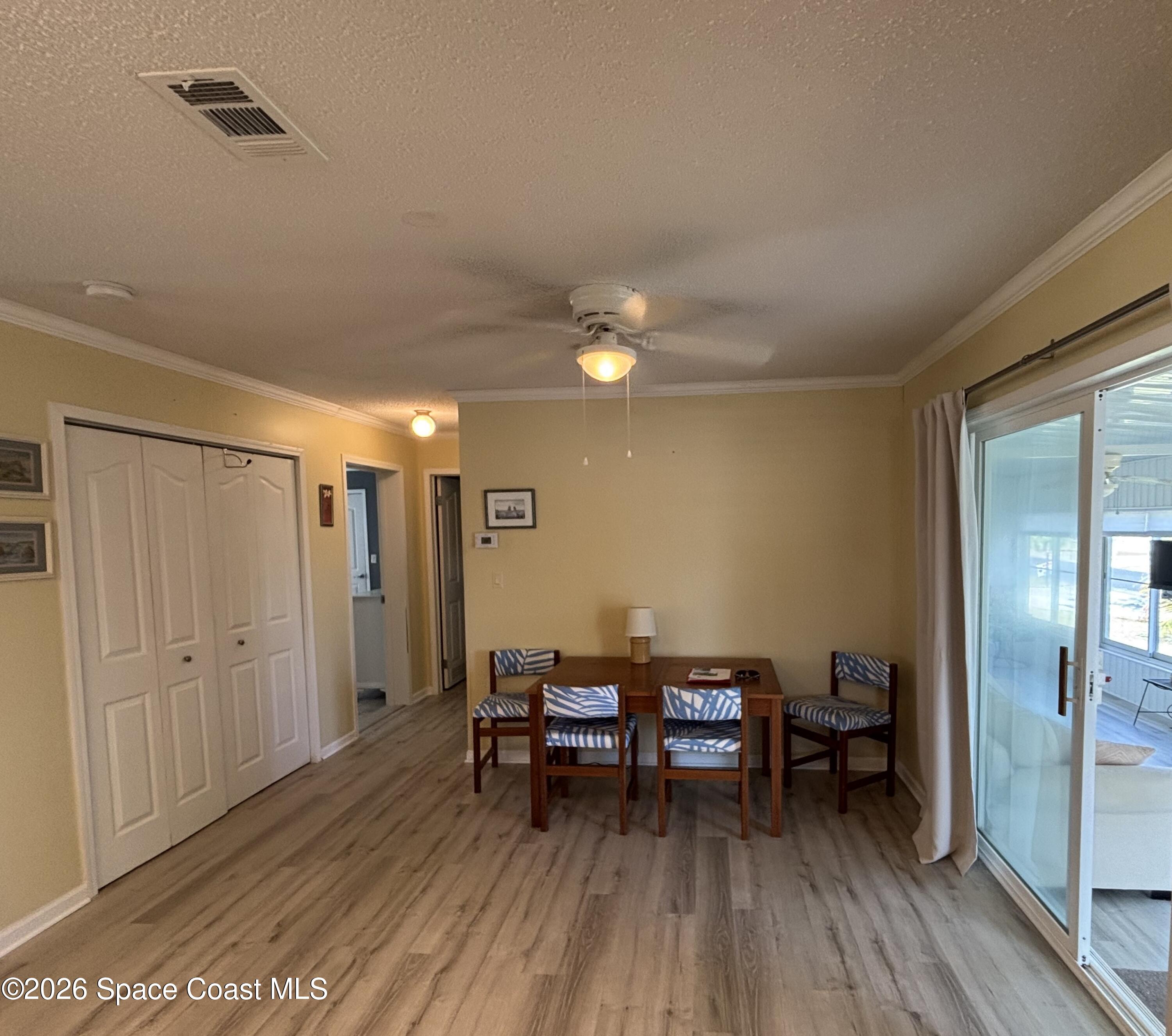 6165 98th Road Sebastian, FL 32958 - Photo 15 of 23 a view of a room with chairs and wooden floor