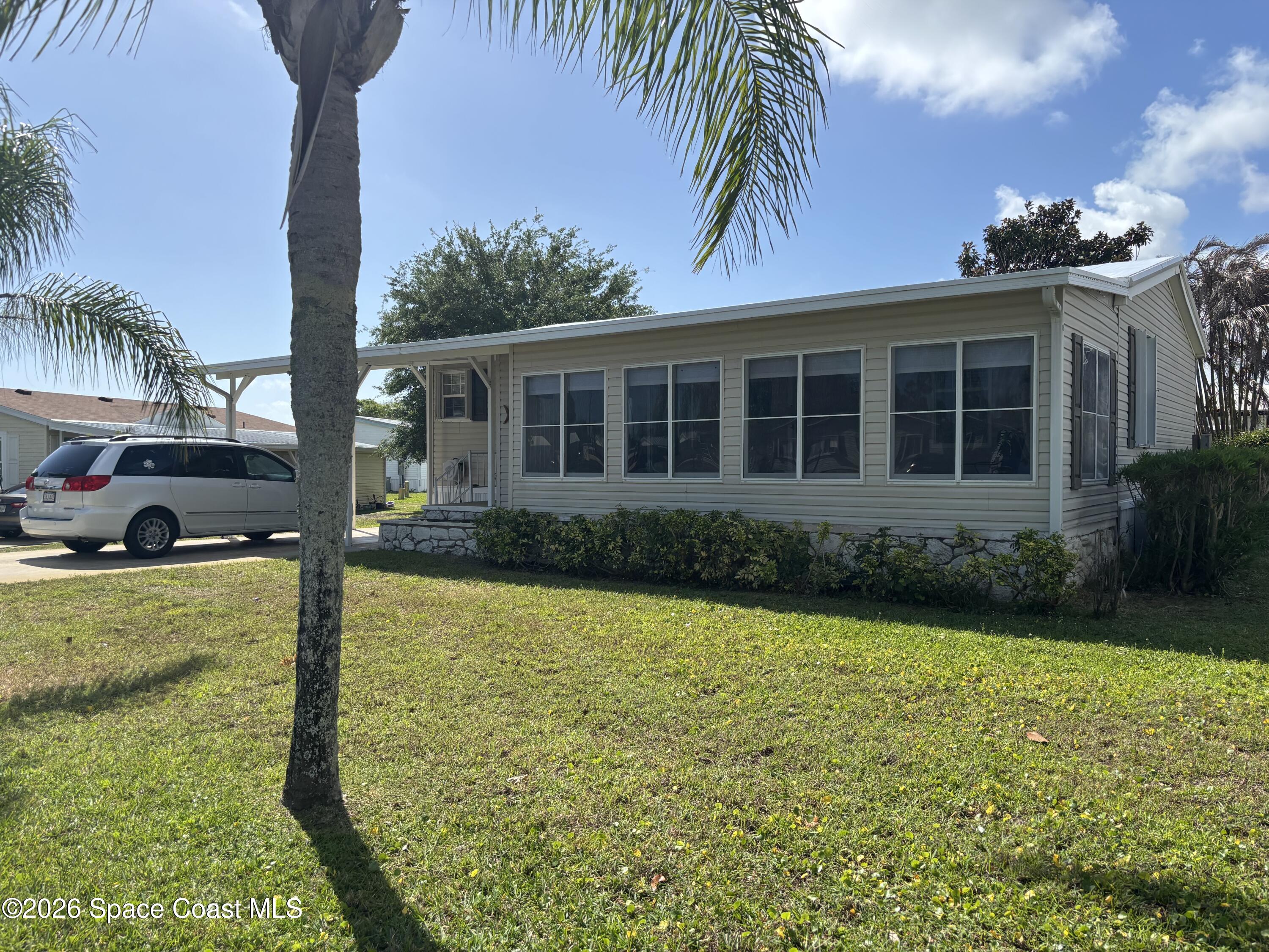 6165 98th Road Sebastian, FL 32958 - Photo 3 of 23 a front view of a house with garden