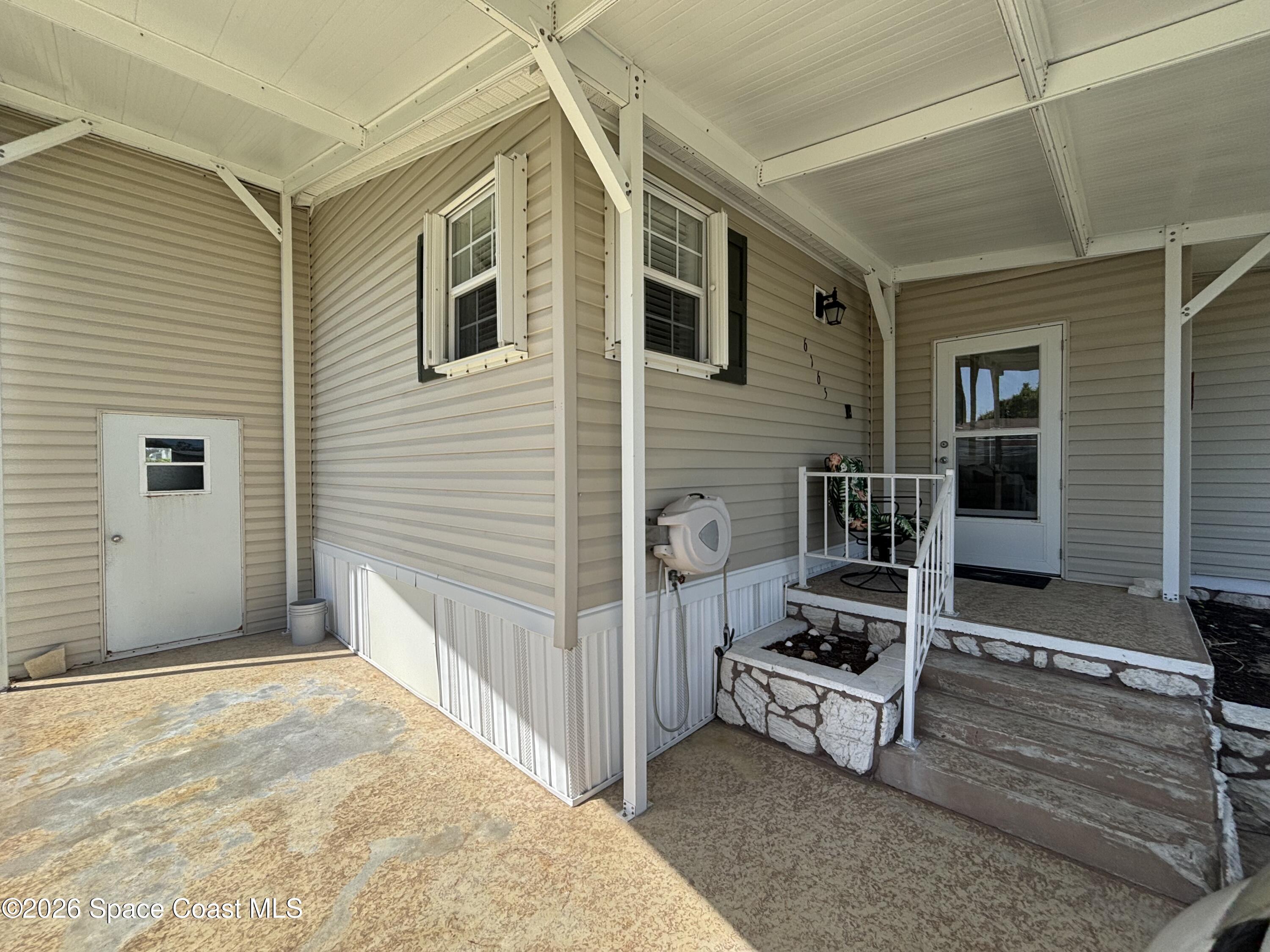 6165 98th Road Sebastian, FL 32958 - Photo 4 of 23 a view of a house with a sink and wooden fence